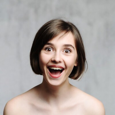 Young woman laughing with wide smile
