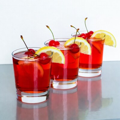 Three Red Cocktails with Cherries and Lemons