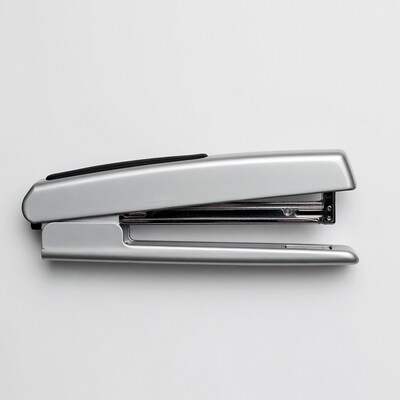 Silver stapler on white background