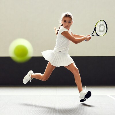 Girl hitting tennis ball