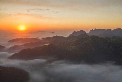 Sunrise over Mountains in Clouds