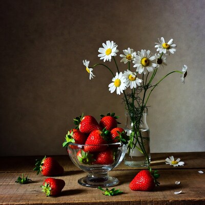 Strawberries and Daisies on Wooden Table