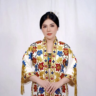 Asian woman in embroidered traditional dress
