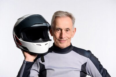 Senior man holding motorcycle helmet