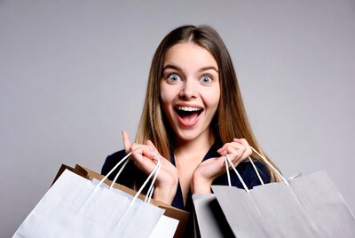 Excited woman holding shopping bags
