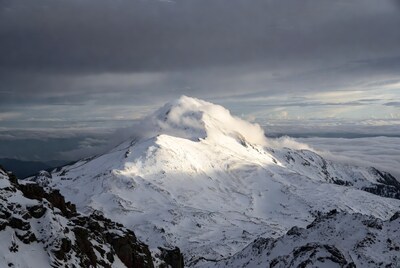 Snowy Mountain Peak Above Clouds