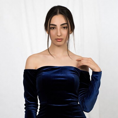 Woman in off-shoulder navy velvet dress