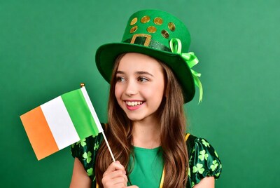 Girl in leprechaun hat holding Irish flag
