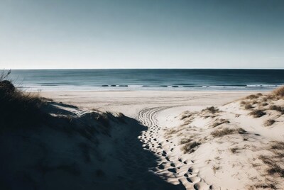 Footprints in sand dunes to ocean