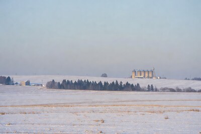 Grain Silos in Snowy Farm Field