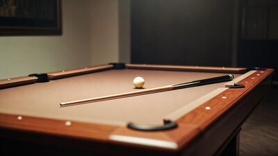 Pool cue and ball on table