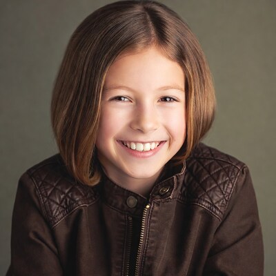 Smiling girl in brown leather jacket