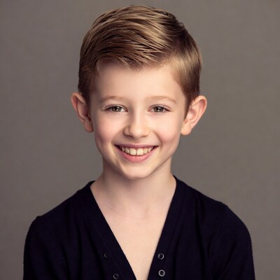 Smiling boy with short blonde hair