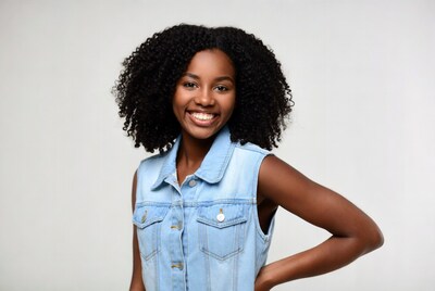 Smiling African-American woman in blue denim vest