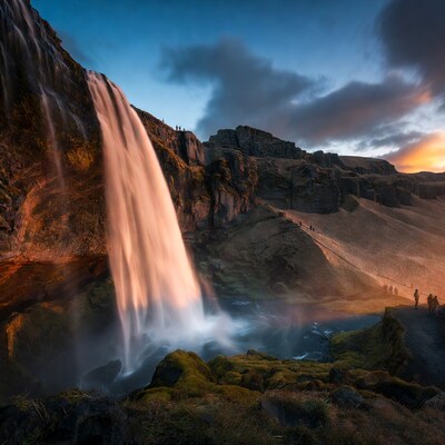 Waterfall with Tourists at Sunset