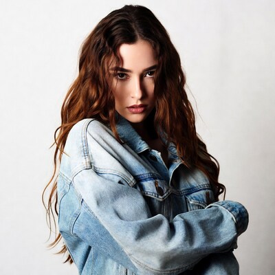 Woman in denim jacket arms crossed