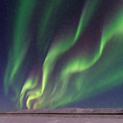 Northern Lights over Snowy Mountains