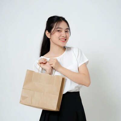 Asian woman holding brown paper bag