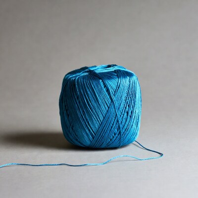 Blue yarn ball on gray background