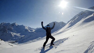 Snowboarder celebrating on snowy mountains