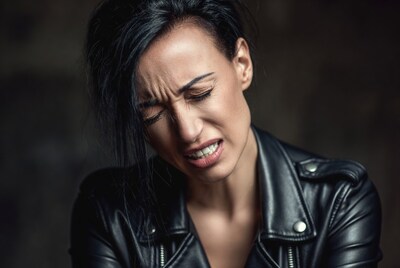 Woman grimacing in leather jacket