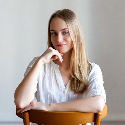 Blonde woman sitting on wooden chair