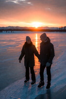 Couple ice skating at sunset