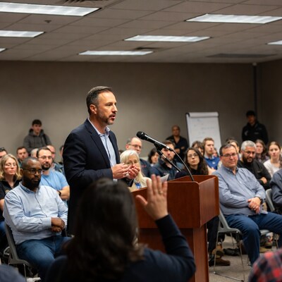 Man speaking at podium in meeting