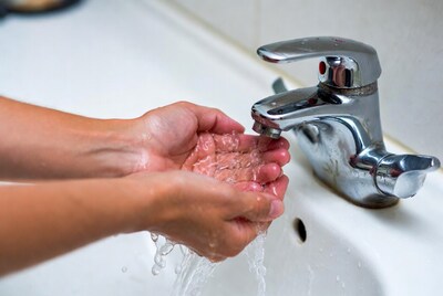 Hands washing under faucet