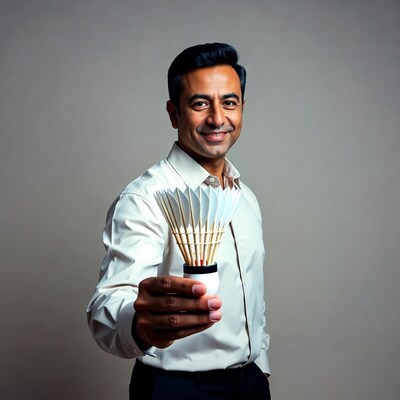 Man holding badminton shuttlecock
