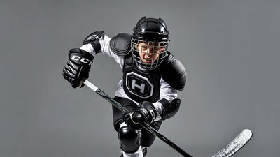 Boy in hockey gear holding stick