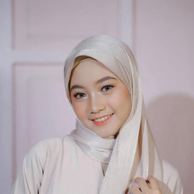 Asian woman in shiny silver hijab