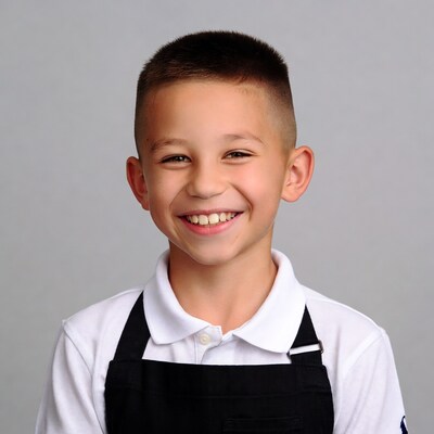 Smiling boy in white shirt and black apron