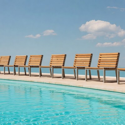 Wooden chairs by swimming pool