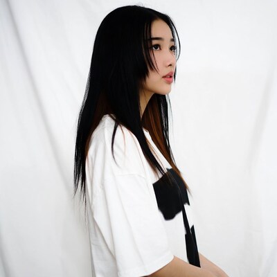 Asian woman in white shirt profile view