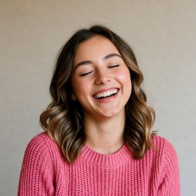 Young woman smiling in pink sweater