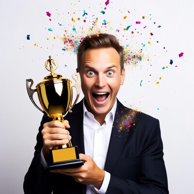 Excited man holding gold trophy