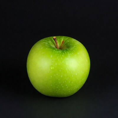 Green apple on black background