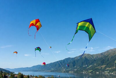 Colorful kites flying over lake mountains