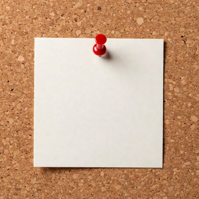 Blank note pinned to corkboard