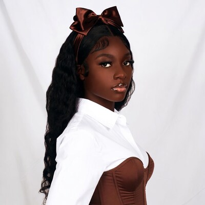 Black woman in brown bow headband