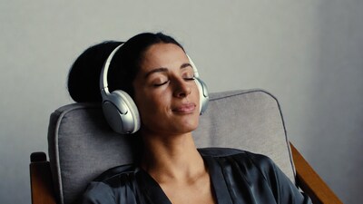 Woman listening with headphones in chair