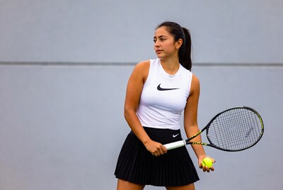 Latina woman holding tennis racket and ball