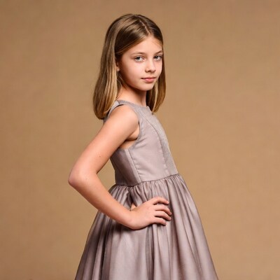 Girl in gray dress posing sideways