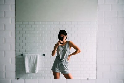 Woman taking mirror selfie in bathroom