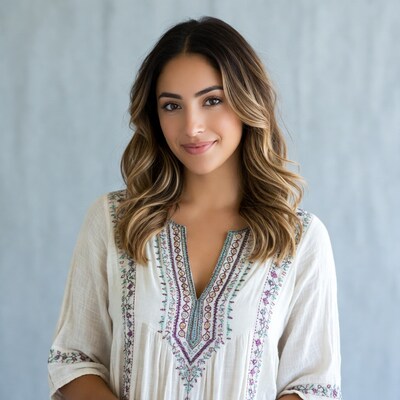 Smiling woman in embroidered white dress