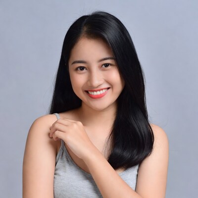 Asian woman smiling in gray tank top