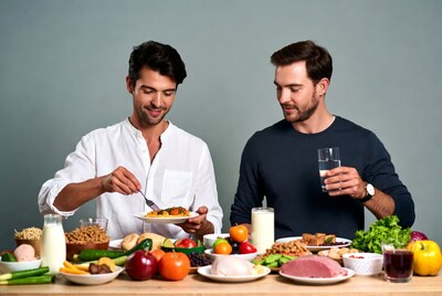 Two men eating at healthy food table