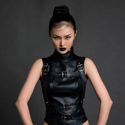 Asian woman in black leather harness