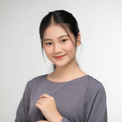 Asian woman smiling in gray top